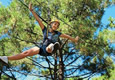 picture of accrobranche: a person moving between trees with ropes